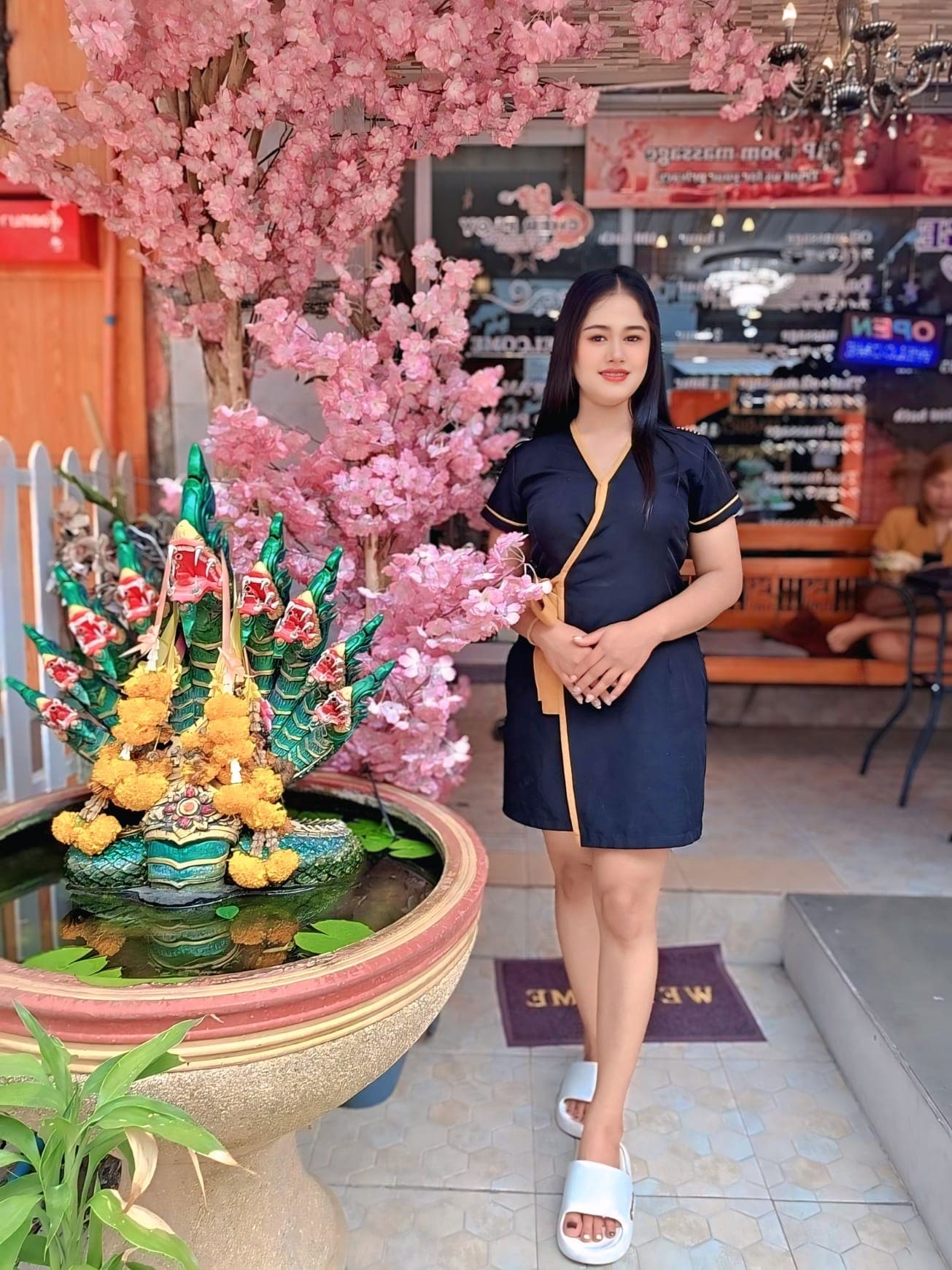Cher Ploy therapist in uniform at the spa entrance