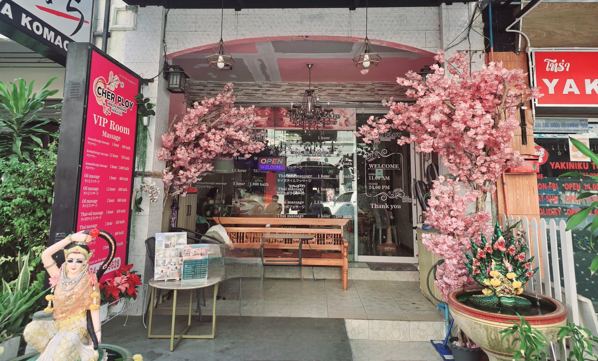 Cher Ploy Health Massage Sriracha — shop entrance with cherry blossom trees
